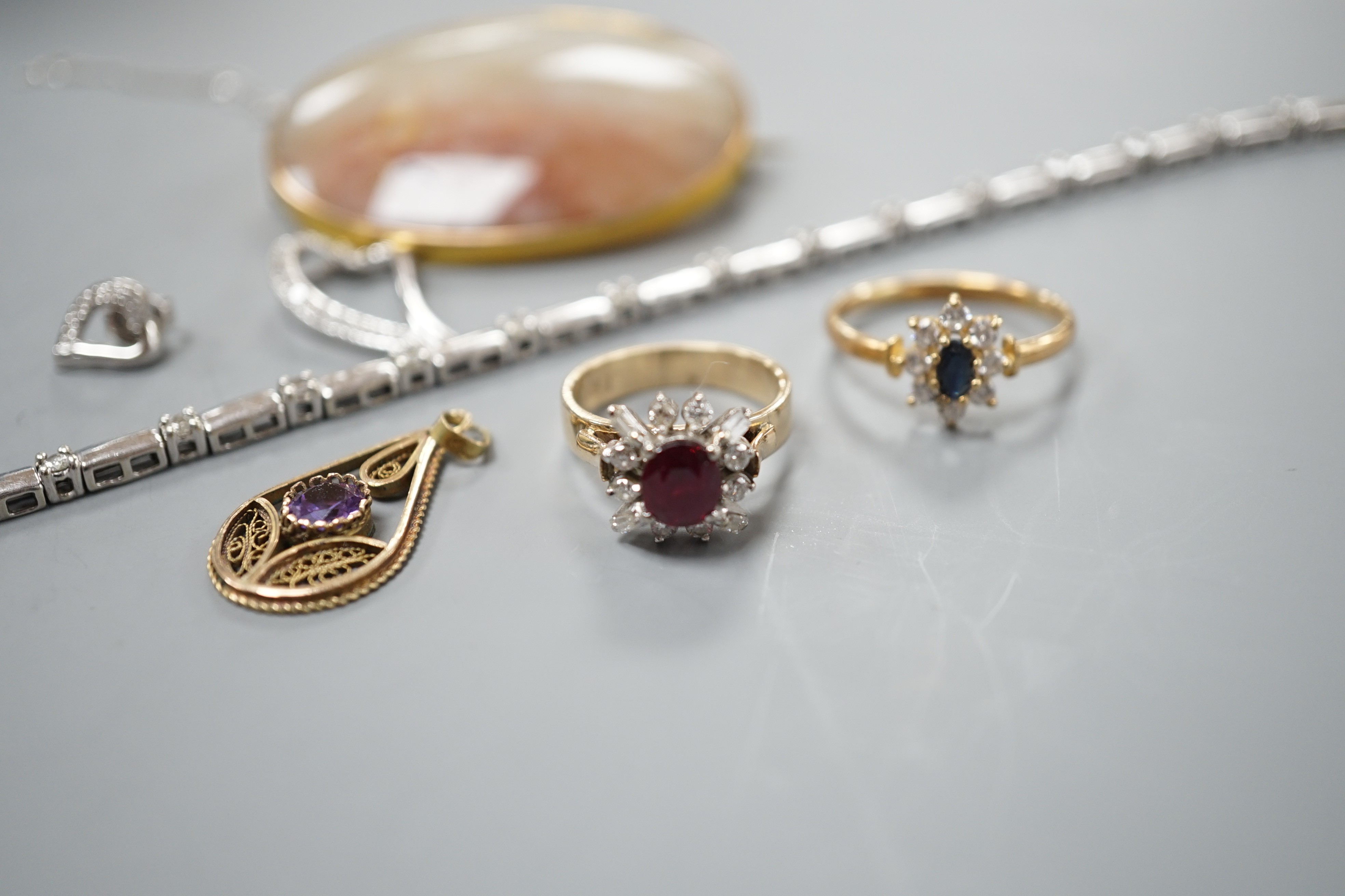 A 9kt white metal and diamond set bracelet, a 9ct mounted agate brooch, two rings including 18k, two pendants and a pair of modern diamond set ear studs.